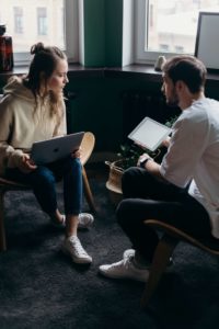 photo-of-couple-talking-while-holding-laptop-and-ipad-4065158