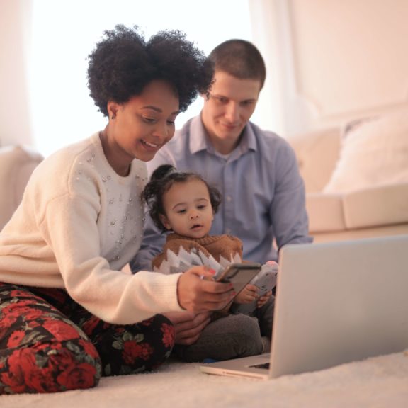 photo-of-woman-using-smartphone-while-sitting-near-her-baby-3820159 (1)